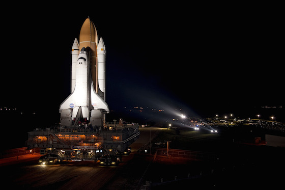 Atlantis Space Shuttle illuminated on on the launch pad awaiting countdown